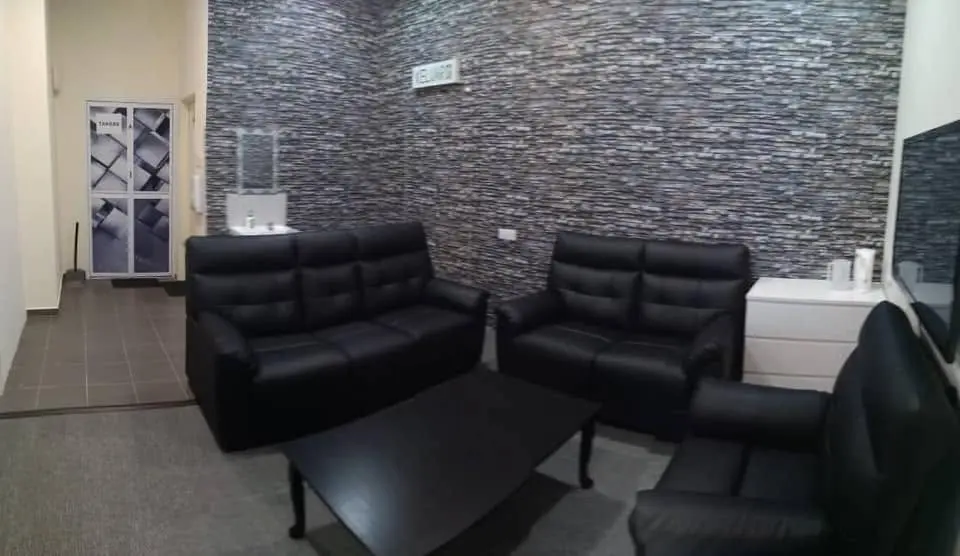 The waiting area at Klinik Lai, with seating and a feature wall.